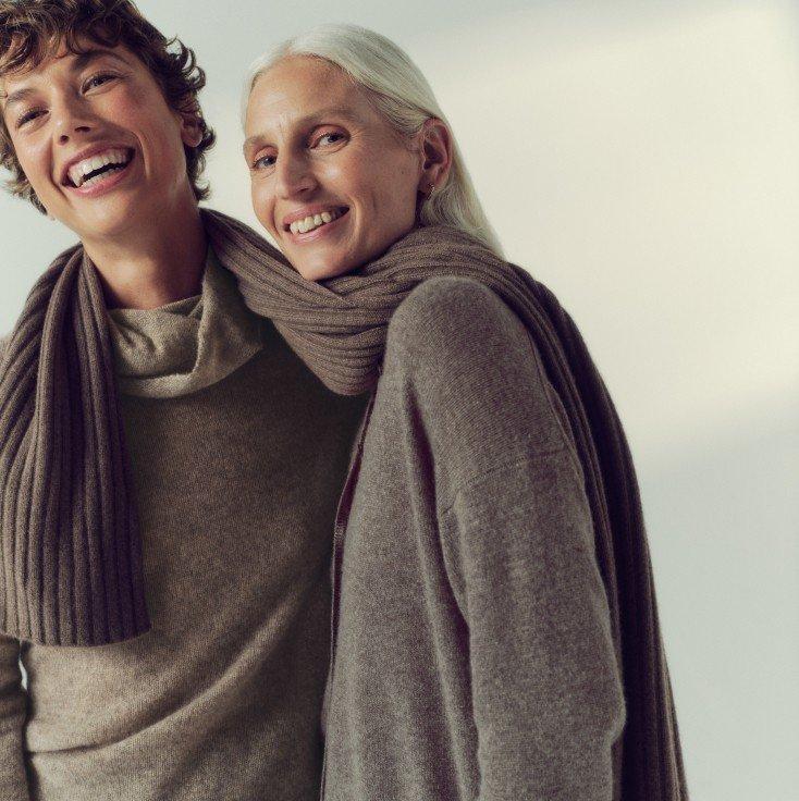 a couple of two people are smiling and hugging each other