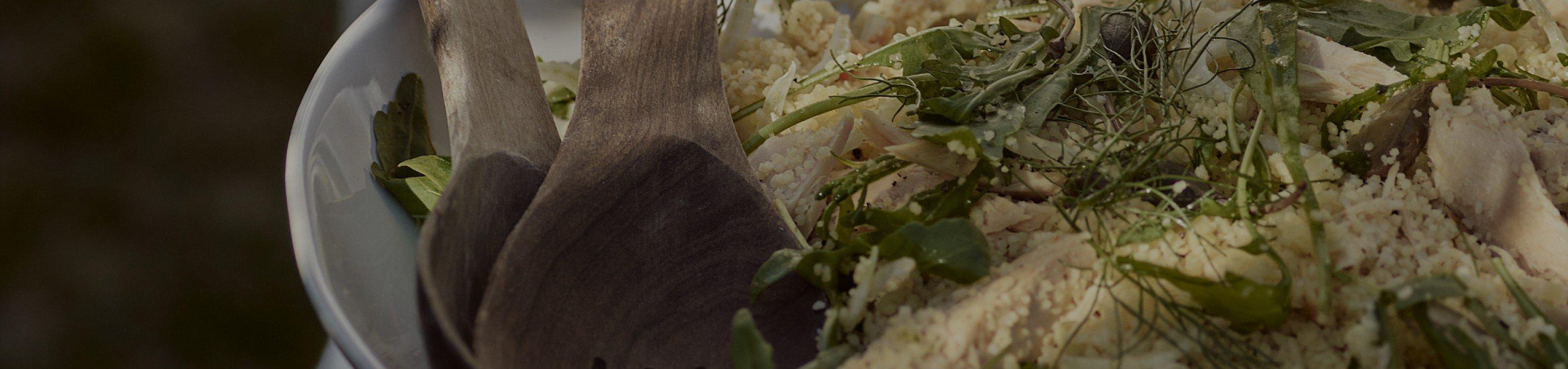 a close up of a bowl of food with wooden spoons