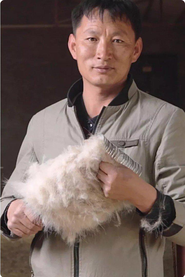 a man holding a piece of fur in his hand