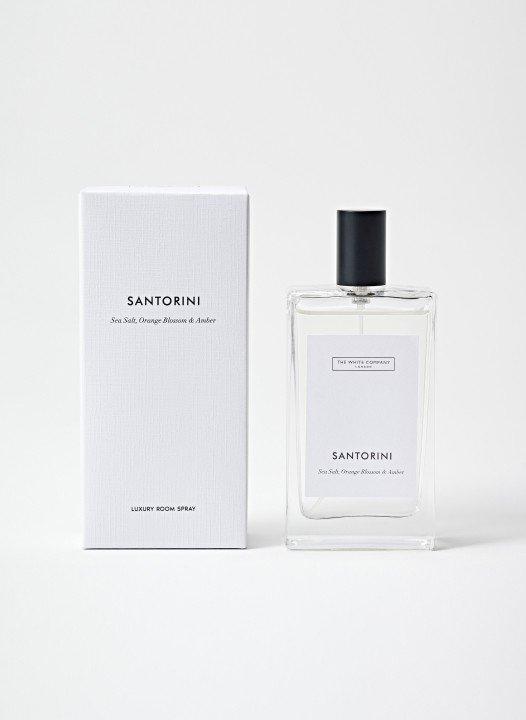 a bottle of santorini perfume next to a box