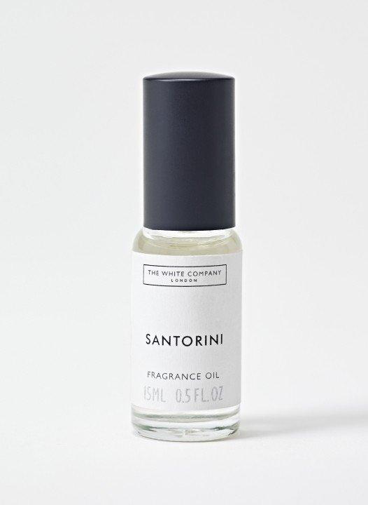 a bottle of santorini perfume on a white surface