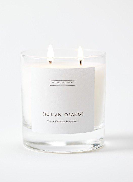 a candle with a label that says sicilian orange