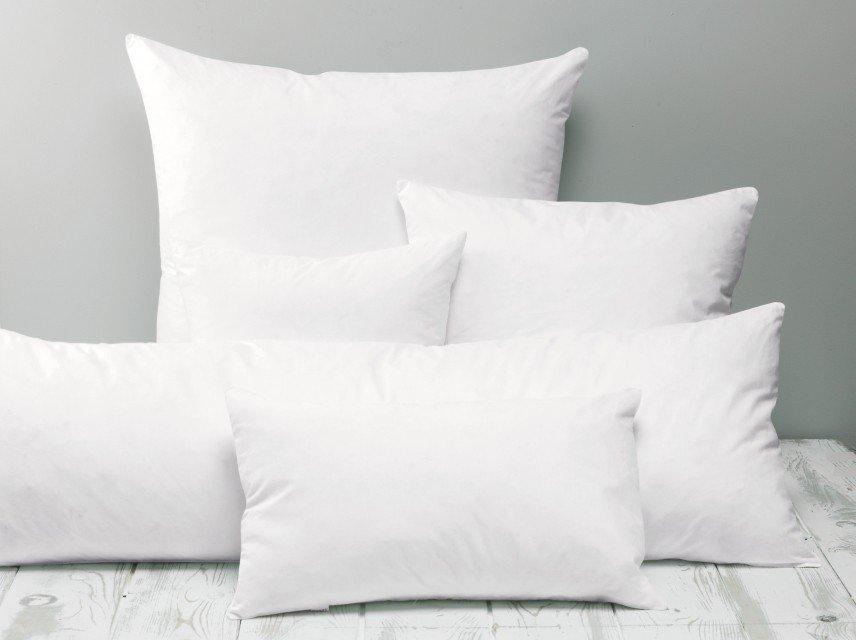 a pillow with a remote control sitting on top of it