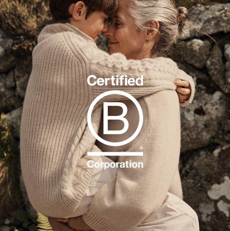 a woman hugging a child with the words certified corporation on the back
