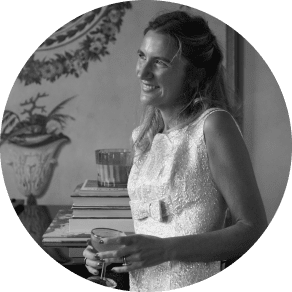 a woman in a dress holding a glass of wine