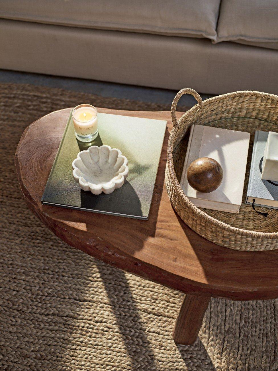 a table with a basket on top of it and a candle on the table