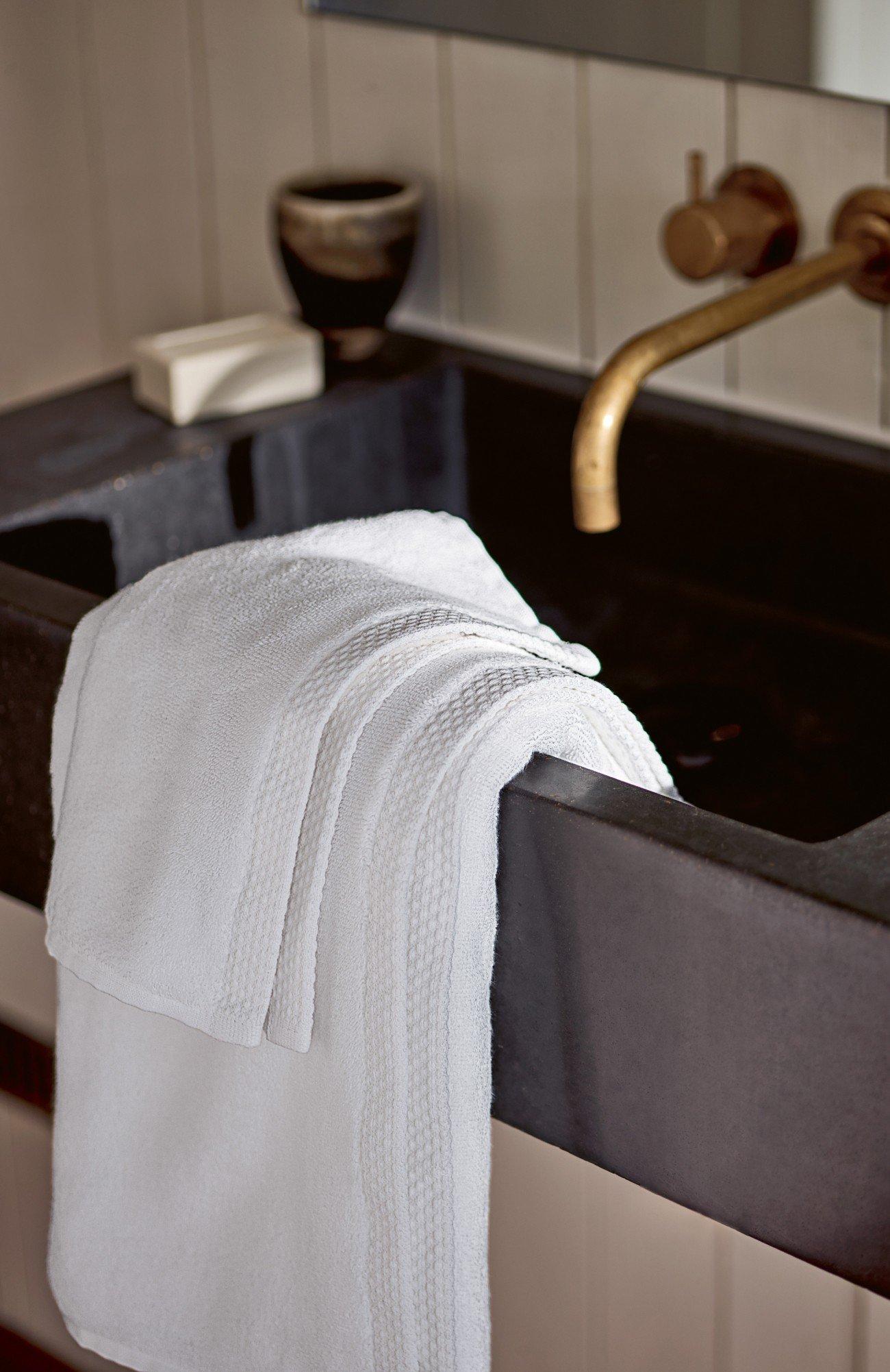 a towel hanging on a sink in a bathroom