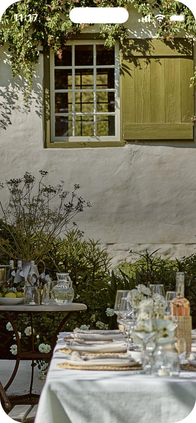 a table with a white cloth and wine glasses on it