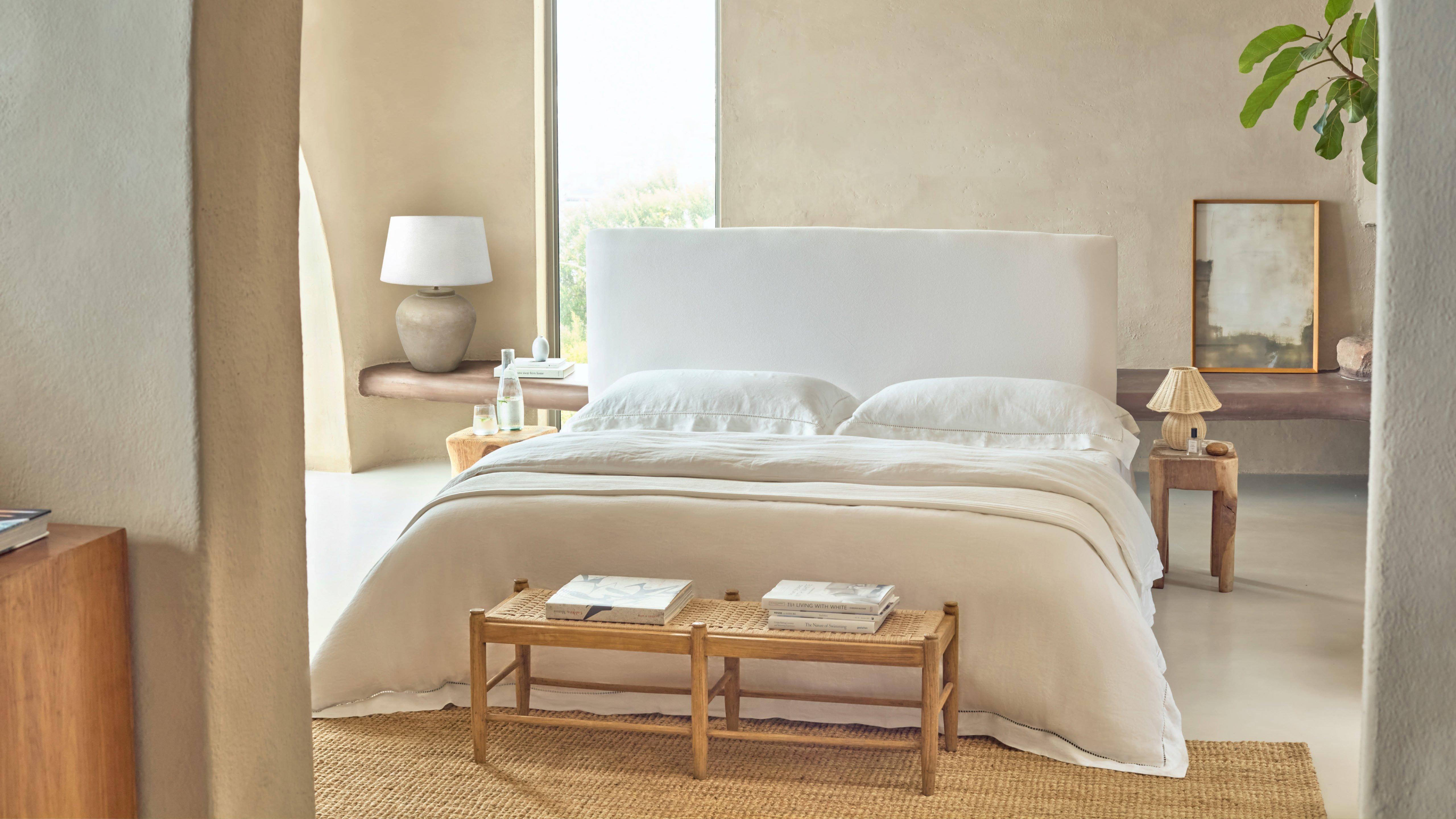 a bedroom with a bed, a table and a lamp