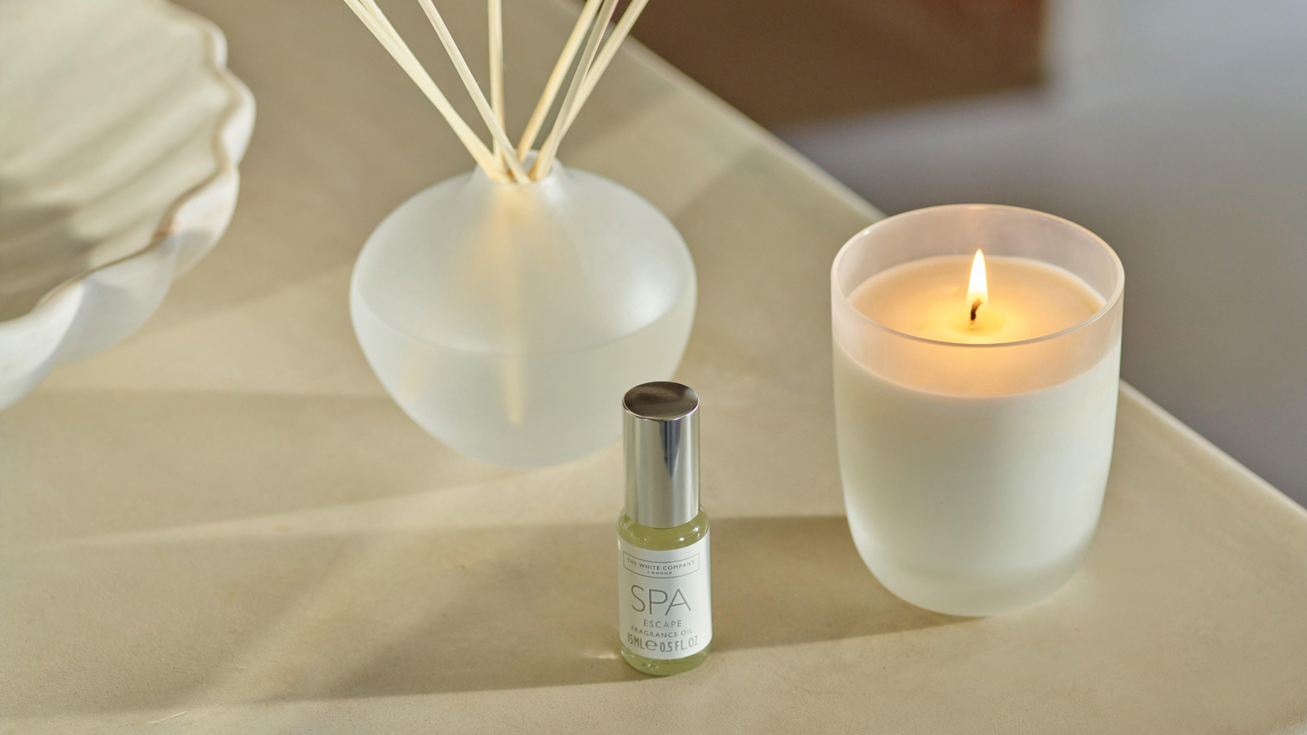 a candle and a vase of flowers sit on a table