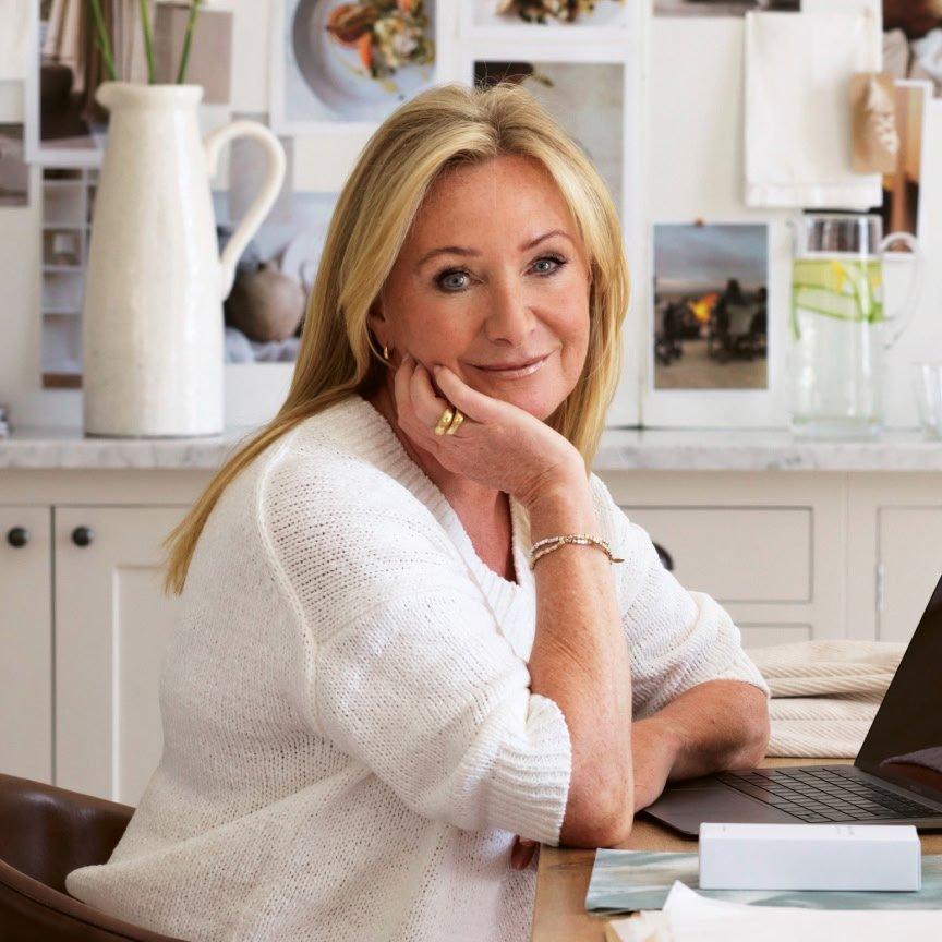 a woman sitting at a desk with a laptop computer