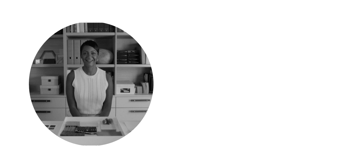 a woman smiling in a black and white photo in a room