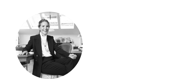 a woman in a white dress sitting on a chair