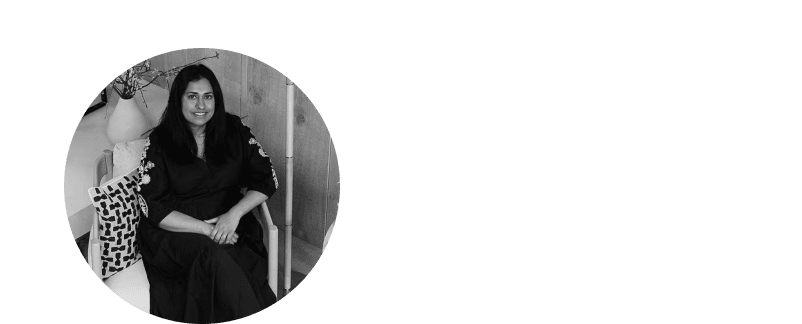 a woman in a black dress sitting on a chair