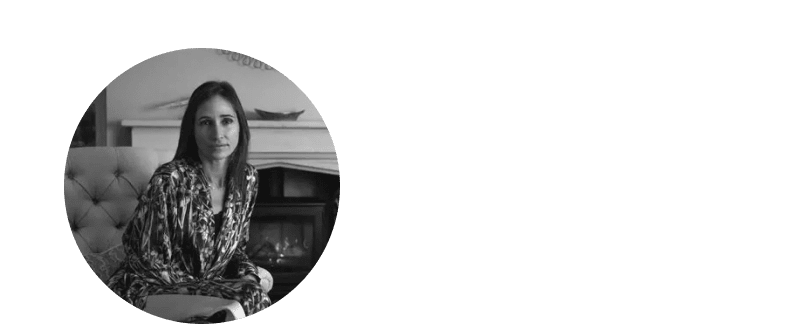 a woman in a black jacket and white blouse