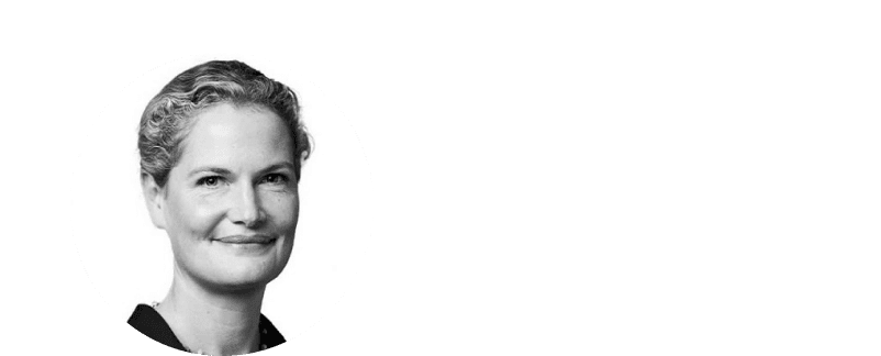 a woman in a white dress sitting on a chair