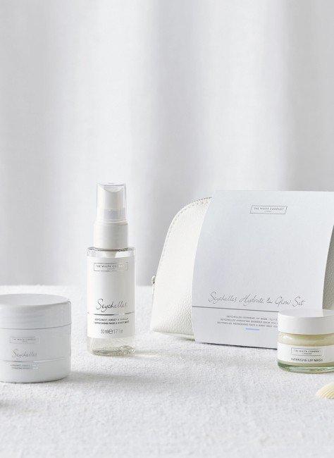 a white products are laid out on a table for a photo shoot