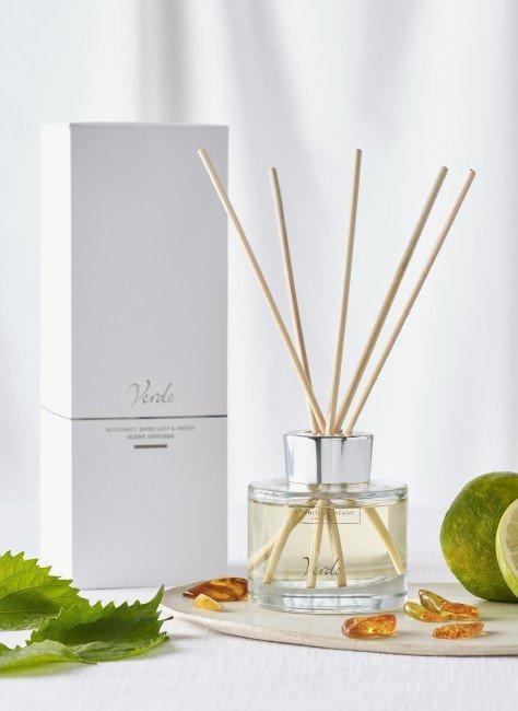 a bottle of reed diffuser, a lime and a leaf