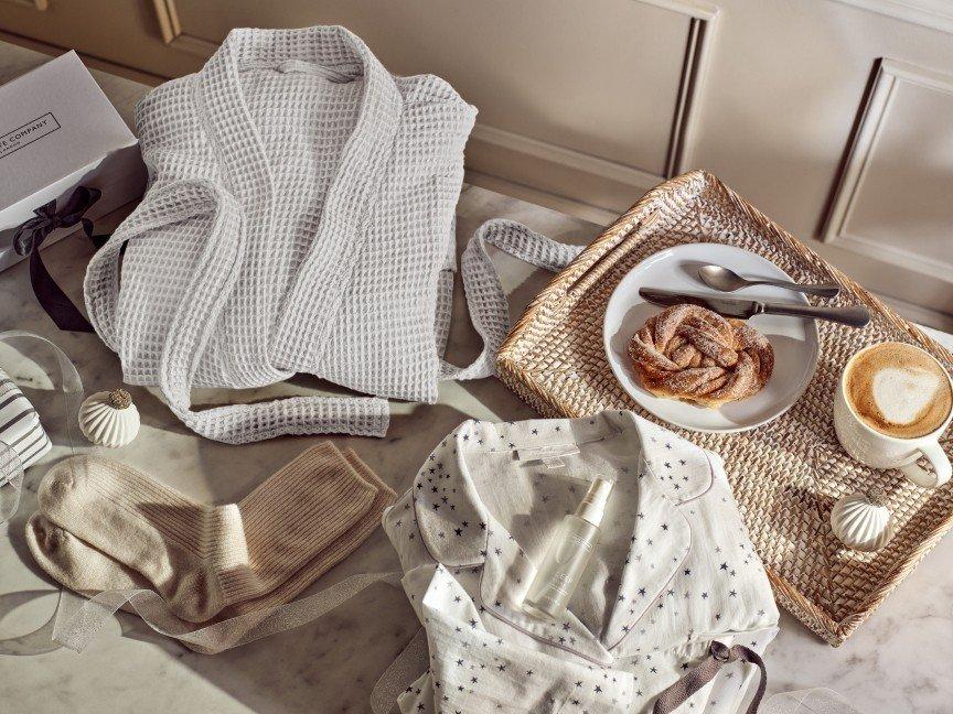 a tray with a coffee cup, a plate of food and a blanket