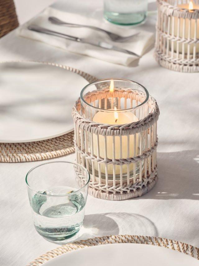 a table with a candle and a glass of water on it