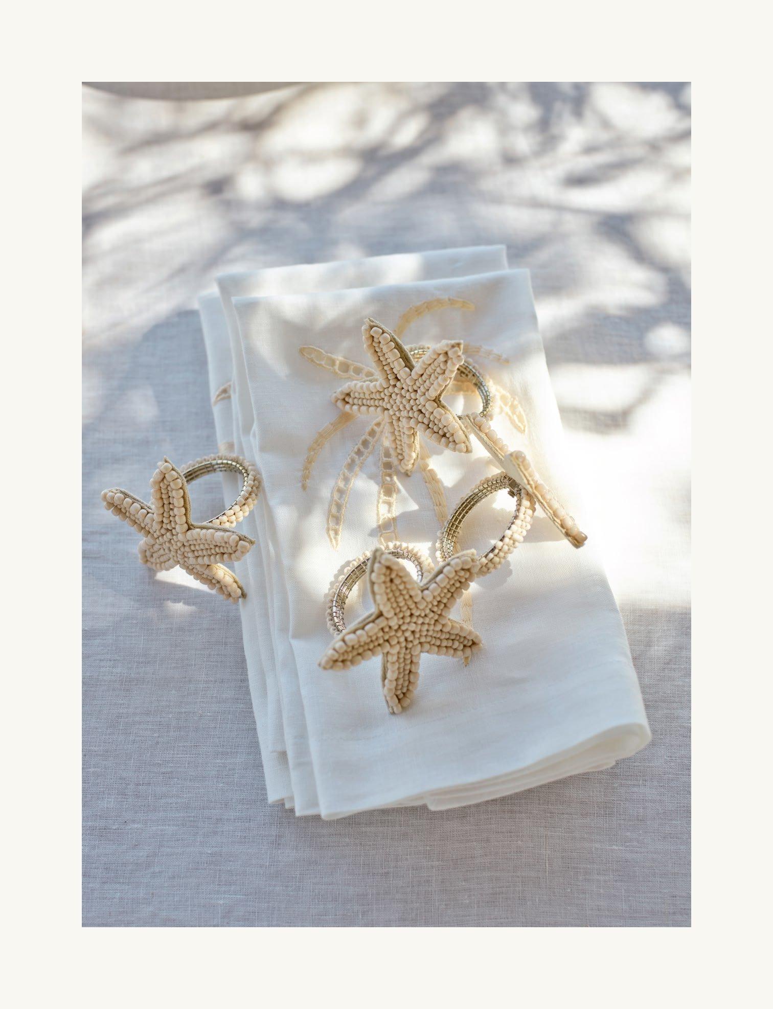 a napkin with a starfish on it and a napkin holder