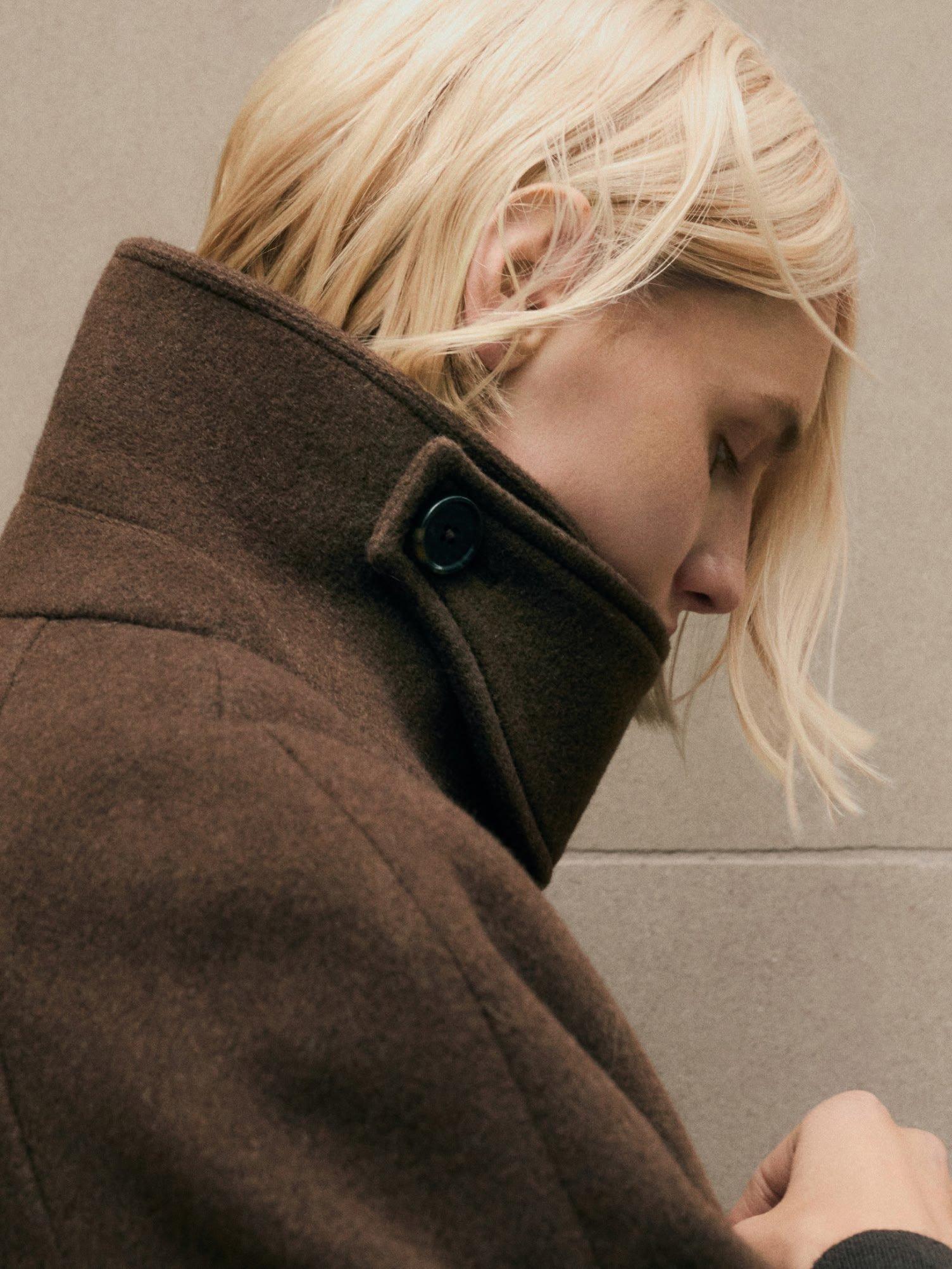 a woman with blonde hair looking at her cell phone