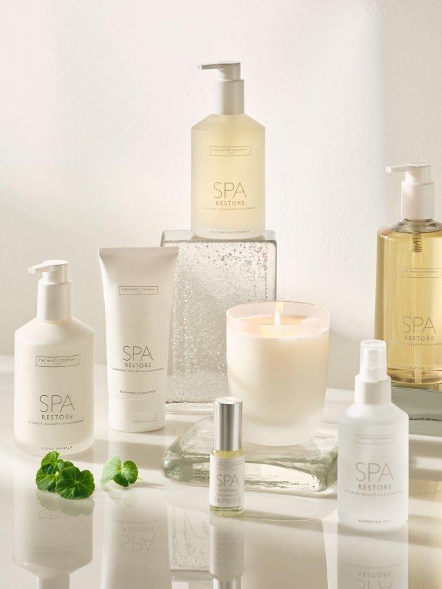 a collection of spa products are displayed on a table