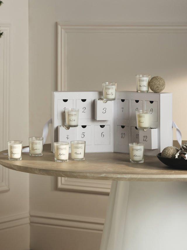 a table with a white box and candles on it