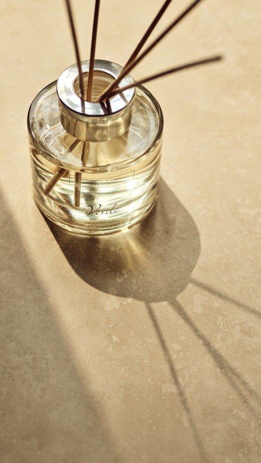 a glass jar with sticks of incense in it on a table