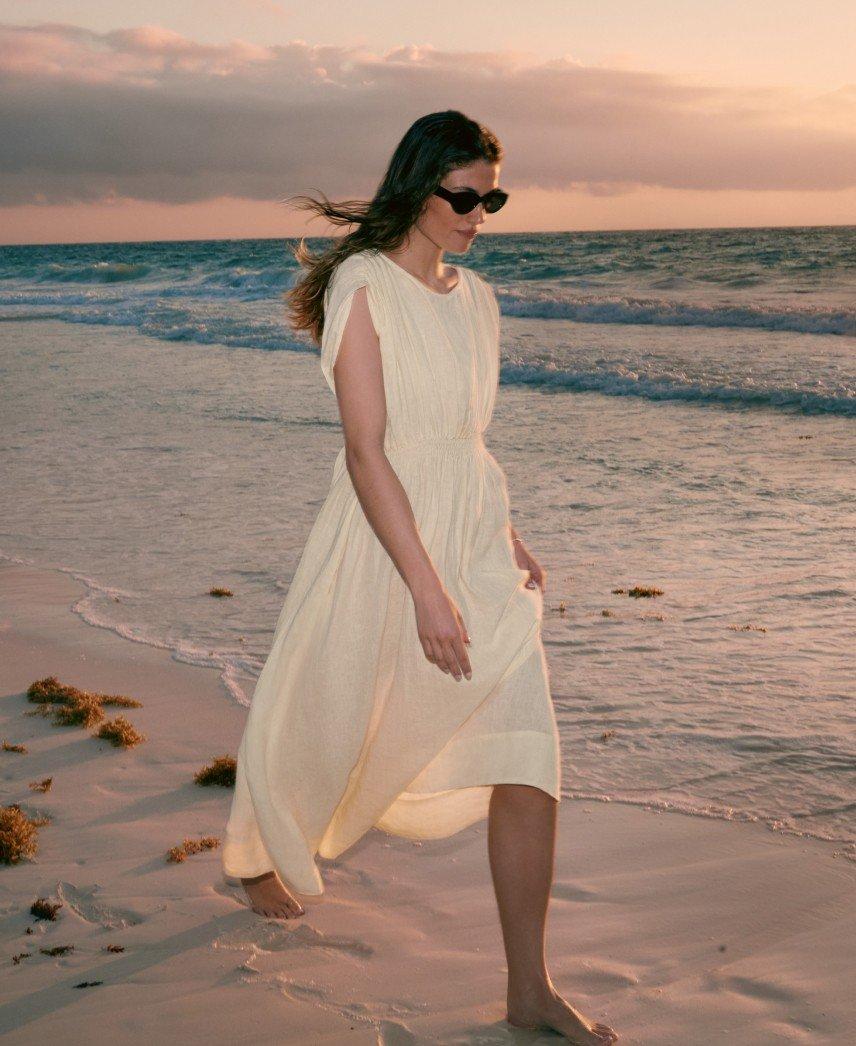 two pictures of a woman in a white dress walking on the beach