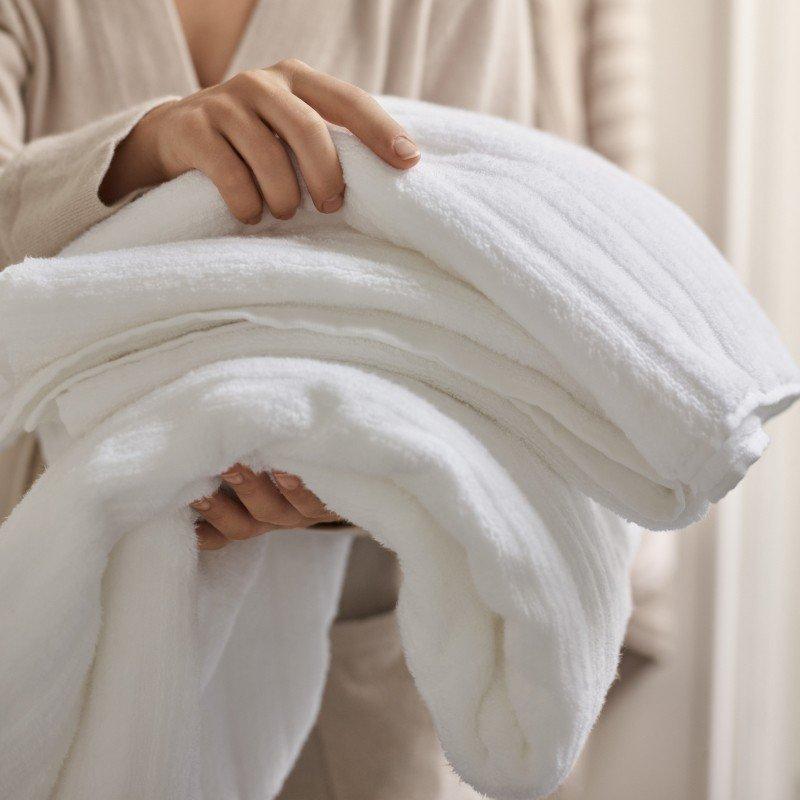 a woman holding towels