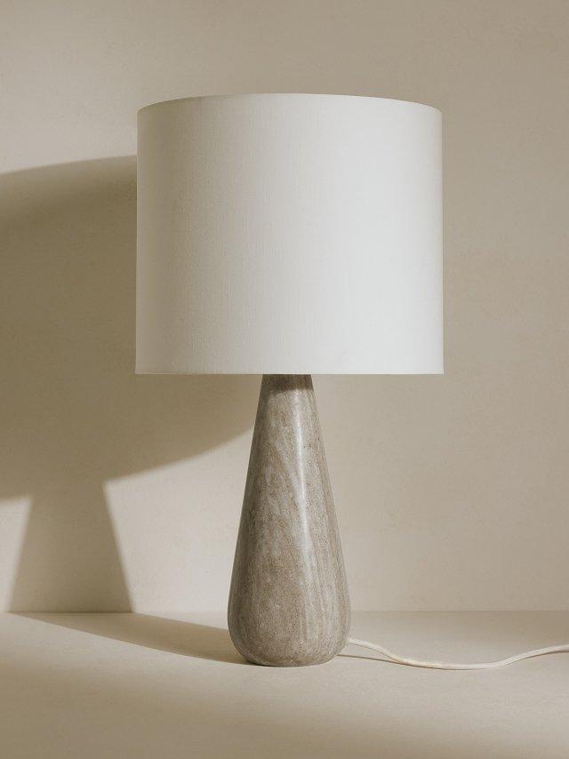 a lamp with a white shade and a yellow light bulb