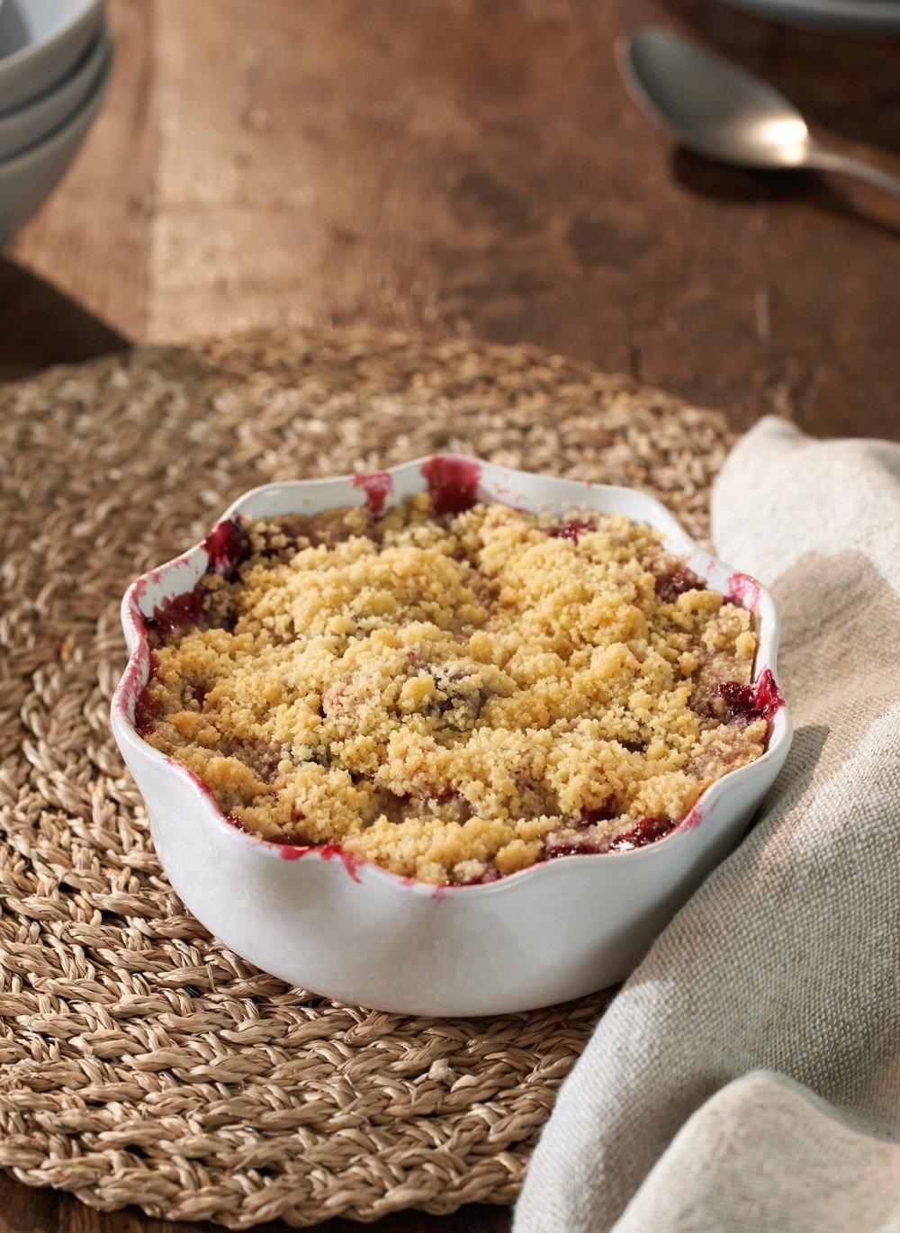 a bowl of a dessert sitting on a table with a spoon