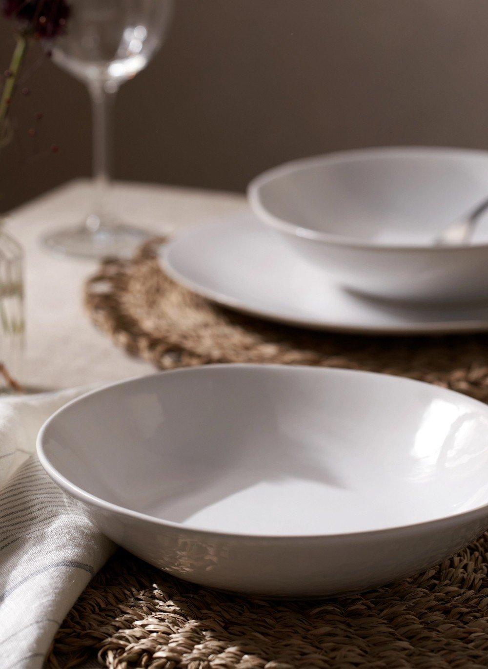 two wine glasses on a table with a napkin on it