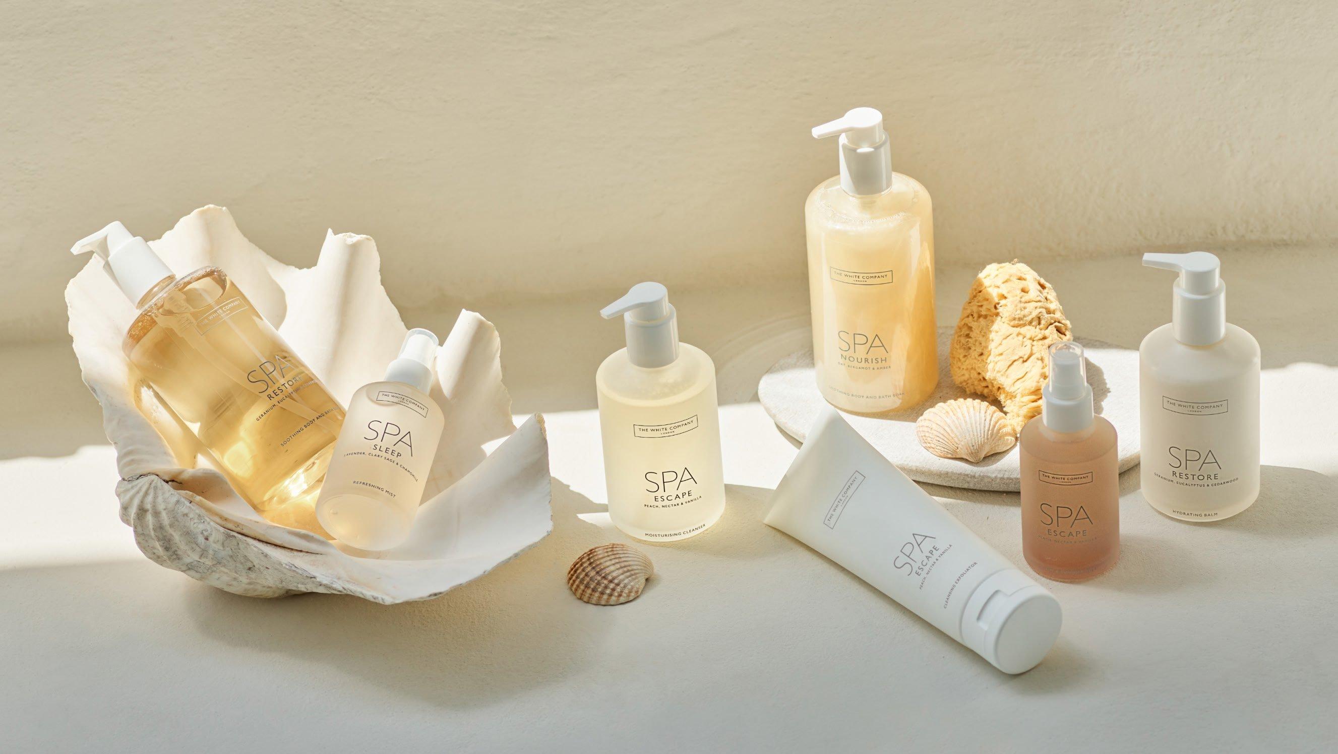 a white shell with shells and a shell on it next to a bottle of lotion