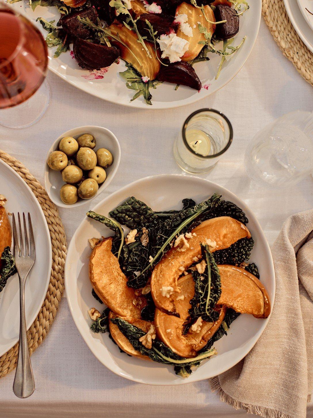 a group of children are gathered around a table with food