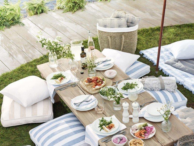 a table topped with plates of food and bowls of salad