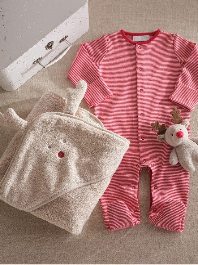 a baby's outfit and accessories are laid out on a table