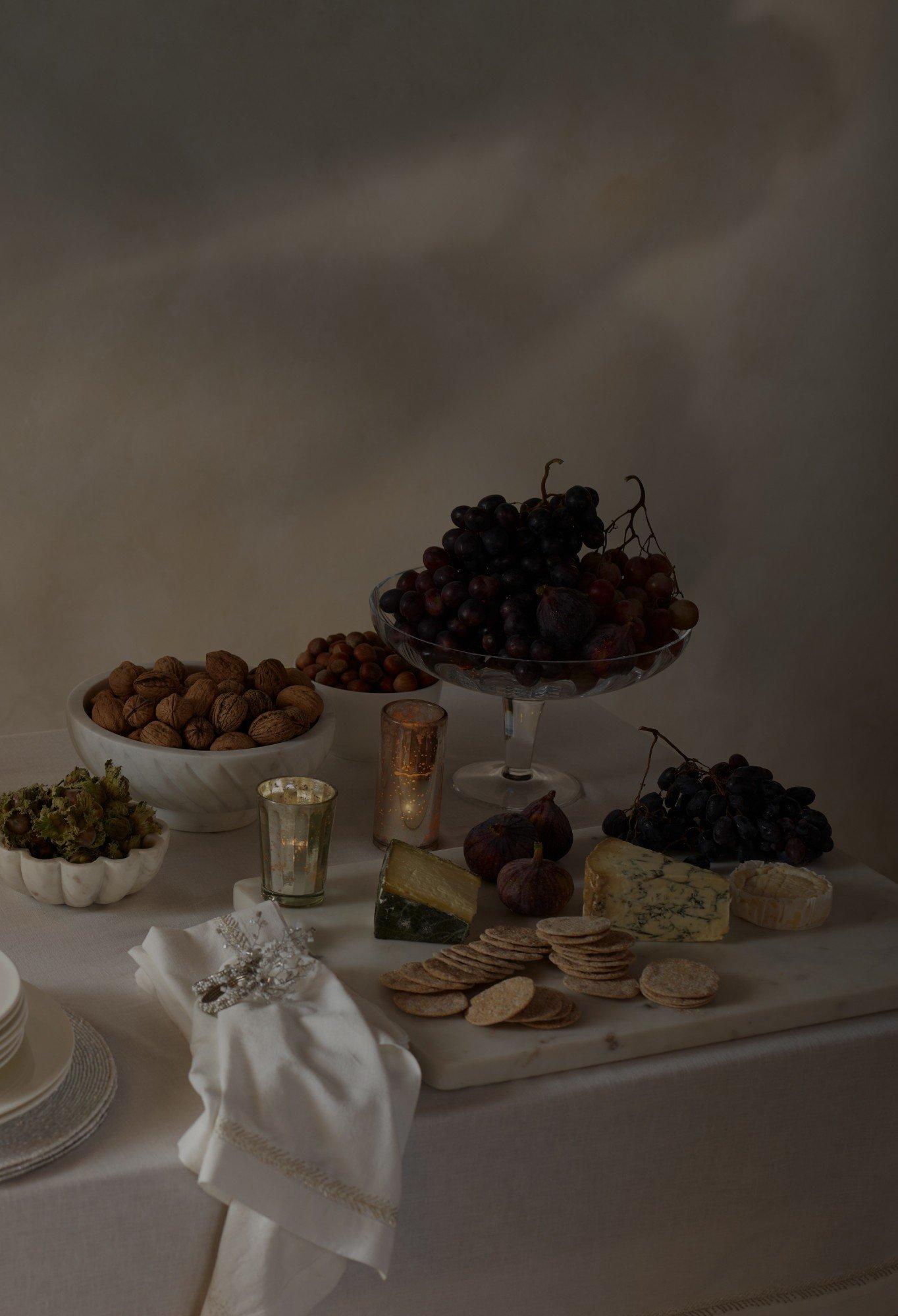 a table with a plate of food and a plate of wine