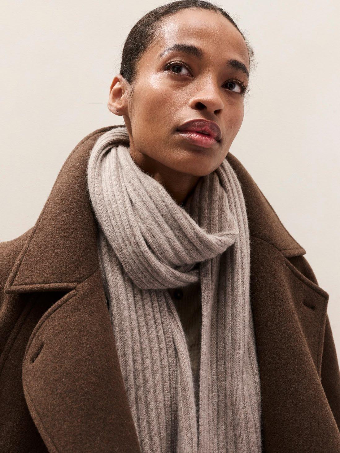 woman in a brown coat and scarf