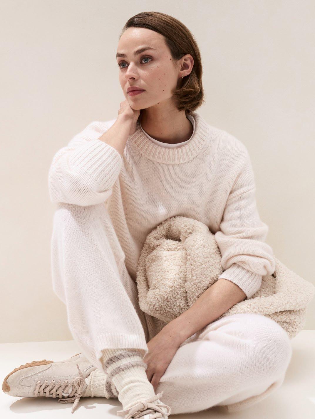 a woman sitting on the floor with a teddy bear