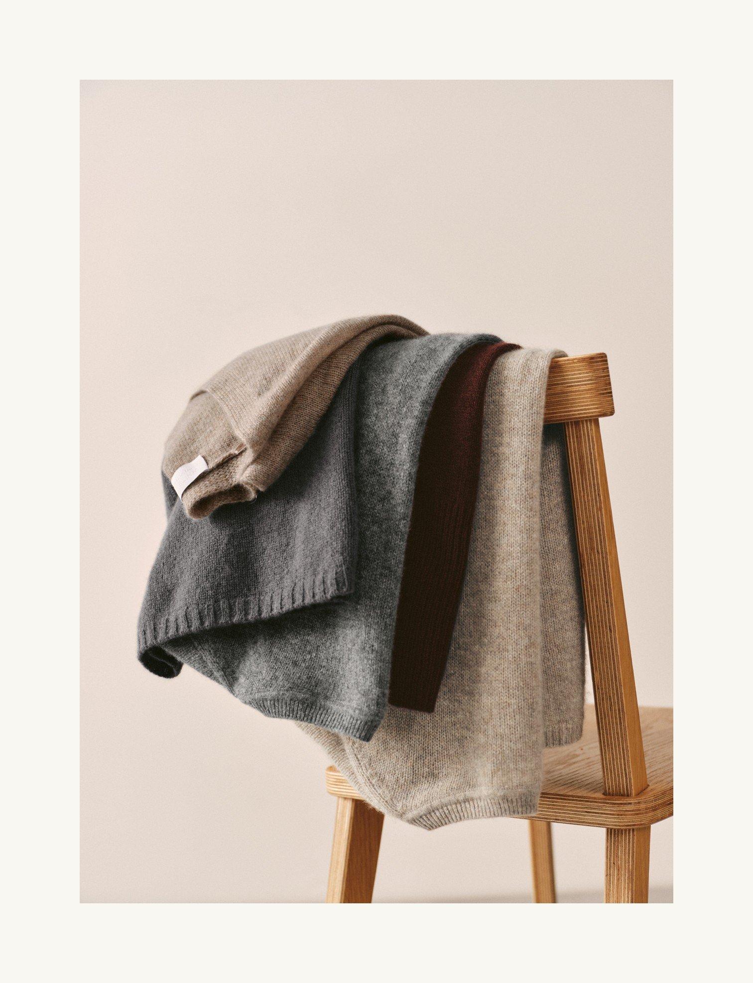 a chair with a pile of blankets on it