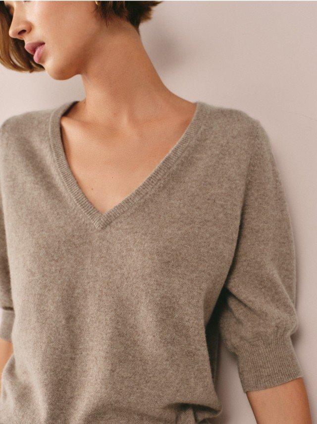 a woman with a yellow disc on her shirt