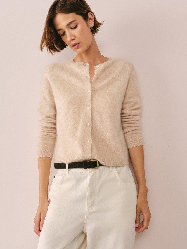 a woman in white pants and a yellow shirt with a yellow circle on it