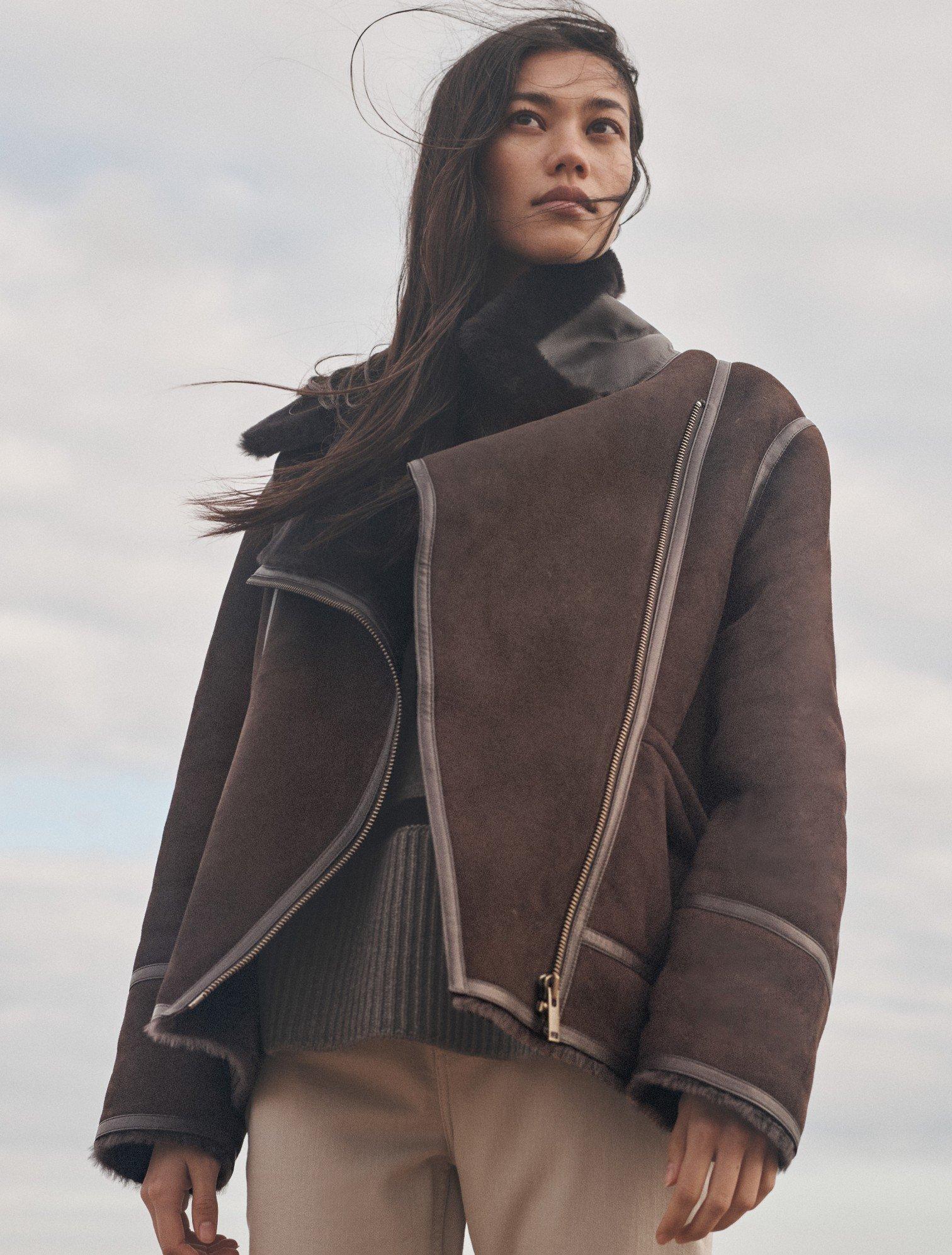 a woman in a shearling coat