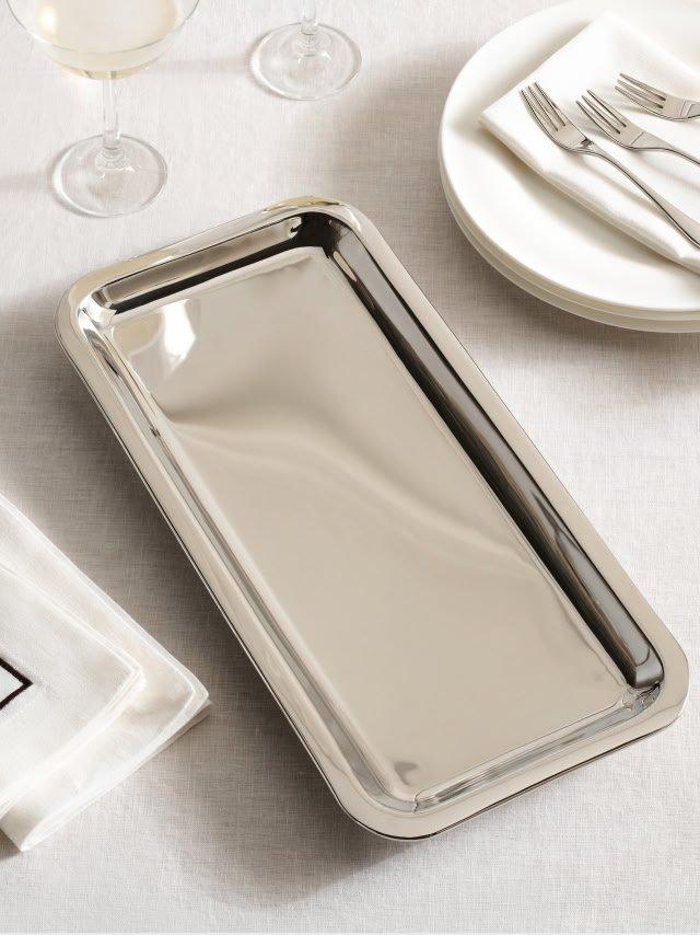 a tray with a silver lid and a fork and knife on it