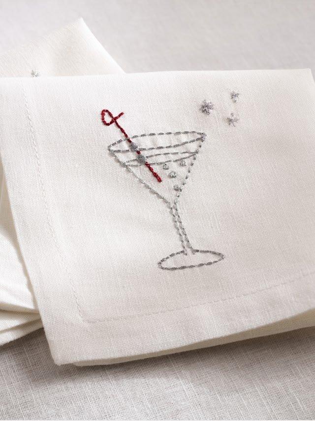 a white napkin with a martini glass embroidered on it