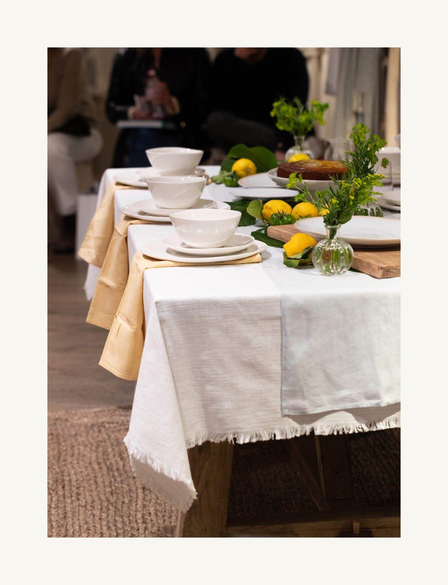 a table with plates and cups and a lemon on it