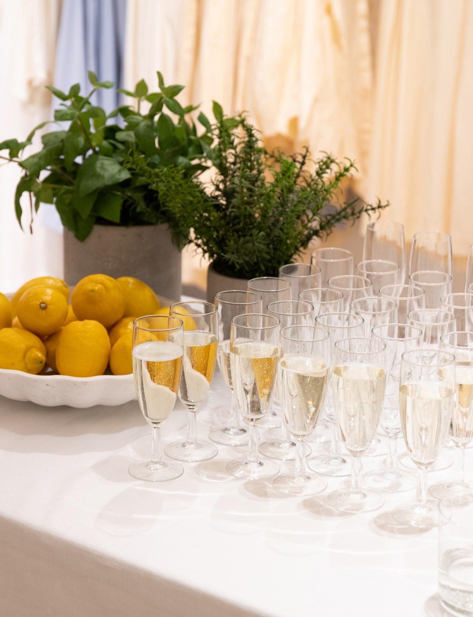 a table with a bunch of glasses and some lemons