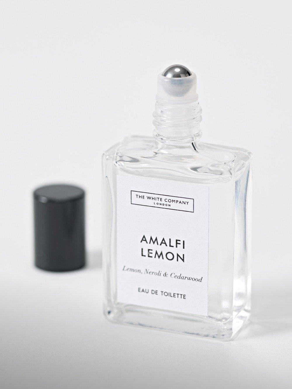 a bottle of perfume with a black cap and a white label